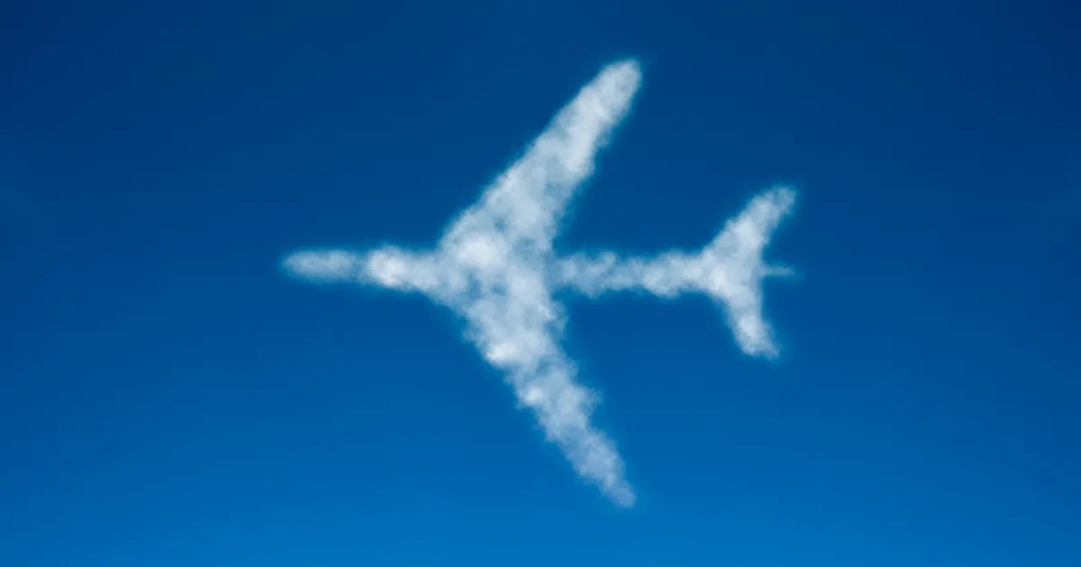 A cloud in the shape of a jet aeroplane, flying from right-to-left, in the blue sky